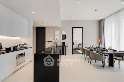 Luxurious open-layout kitchen and dining area with modern furnishings and elegant decor.