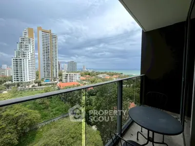 Stunning balcony view overlooking cityscape and ocean, perfect for relaxation.