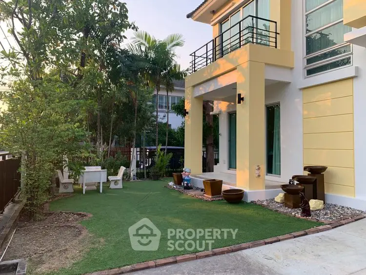 Charming modern home with lush garden and inviting outdoor seating area