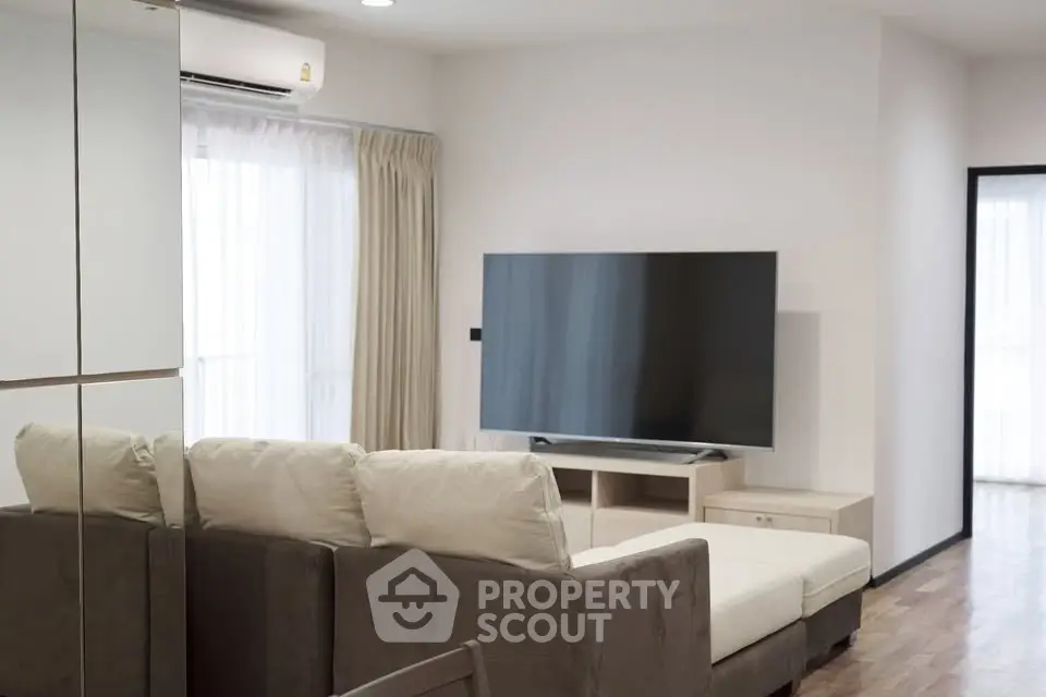 Modern living room with large TV and comfortable sofa in a bright apartment