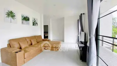 Spacious living room with modern decor and large windows offering natural light.