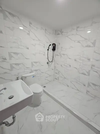 Modern bathroom with marble tiles and sleek fixtures