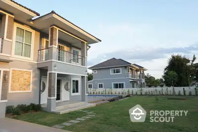 Modern two-story house with spacious lawn and elegant facade