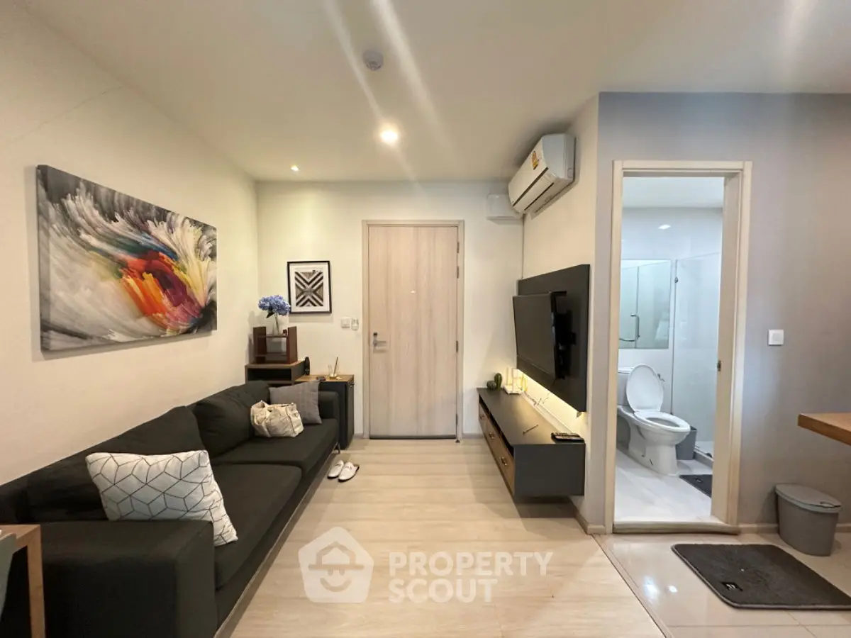 Modern living room with sleek furniture and bathroom view