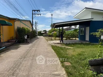 Charming suburban street with modern house and lush greenery, perfect for tranquil living.