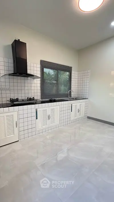 Modern kitchen with sleek gas stove and tiled backsplash
