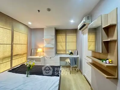 Modern bedroom with stylish decor, built-in shelves, and cozy lighting for a comfortable living experience.