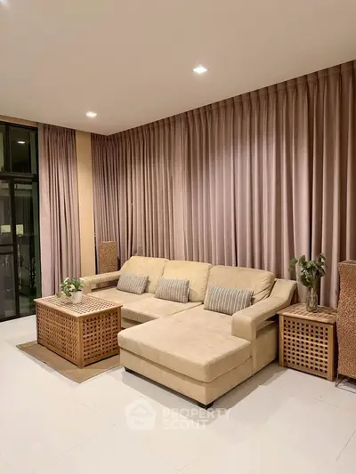 Elegant living room with beige sectional sofa and stylish decor, perfect for modern comfort and relaxation.