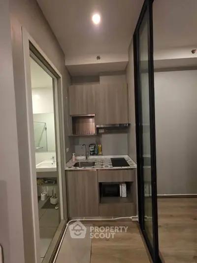 Modern compact kitchen with sleek cabinetry and built-in appliances