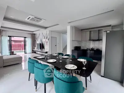 Luxurious open-plan living and dining area with modern kitchen and elegant decor.