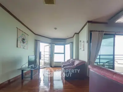 Spacious living room with ocean view and elegant leather seating