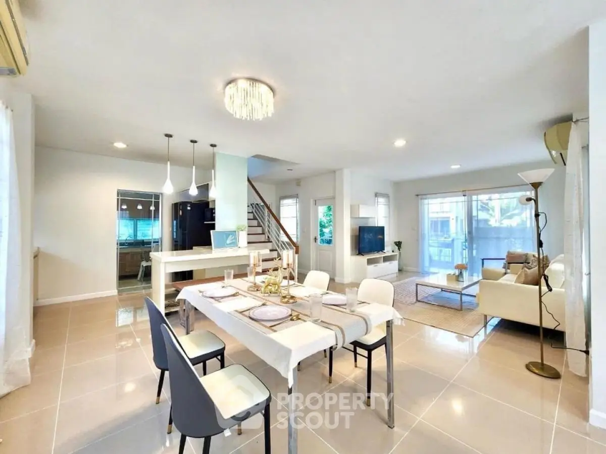 Spacious open-plan living and dining area with modern decor and natural light
