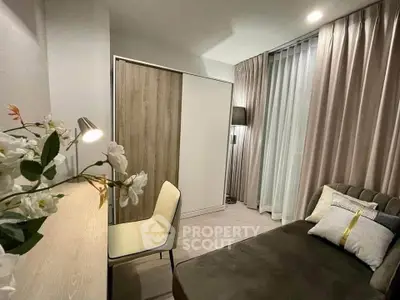 Cozy bedroom with modern decor, featuring a comfortable bed, stylish wardrobe, and elegant lighting.