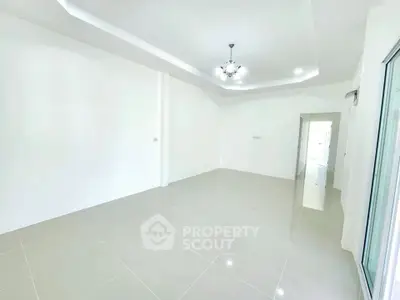 Spacious empty room with modern lighting and glossy tiled floors