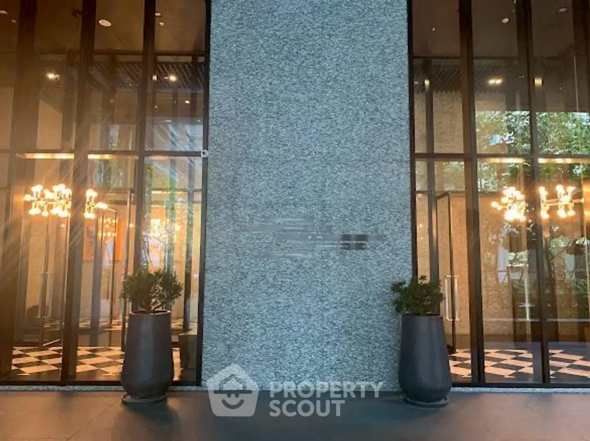 Elegant building entrance with modern glass doors and stylish lighting