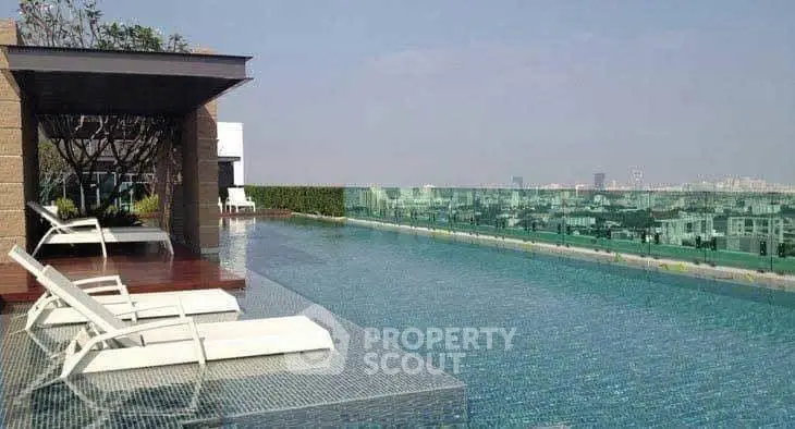 Luxurious rooftop infinity pool with stunning city views and modern lounge chairs.