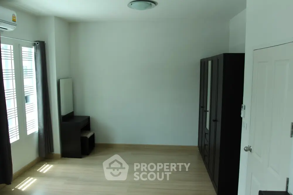 Spacious bedroom with modern wardrobe and natural light