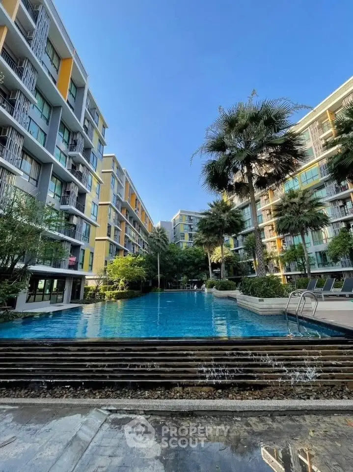 Luxurious residential complex with stunning pool and lush greenery, perfect for modern living.