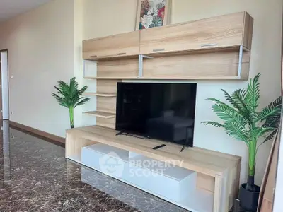 Modern living room with sleek TV unit and marble flooring