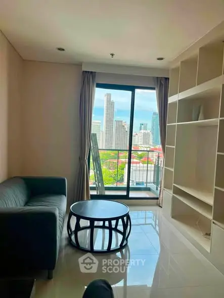 Modern living room with city view and balcony access in high-rise apartment