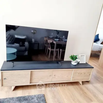 Modern living room with sleek TV stand and stylish decor, showcasing contemporary interior design.