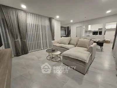 Spacious modern living room with elegant decor and open layout, perfect for family gatherings.