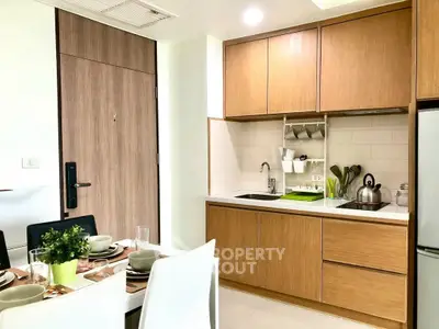 Modern kitchen with wooden cabinets and dining area in a stylish apartment