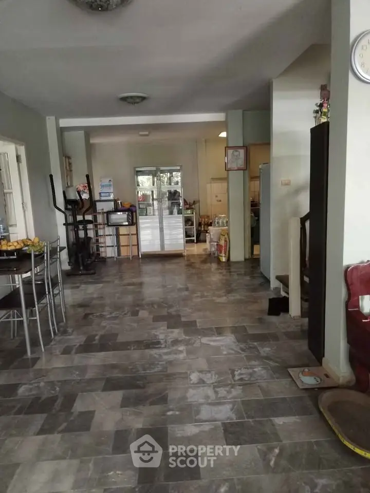 Spacious open-plan living area with modern flooring and ample natural light, perfect for family gatherings.