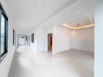 Spacious modern living room with elegant lighting and large windows