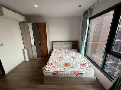 Modern bedroom with large window and stylish wardrobe in a cozy apartment.