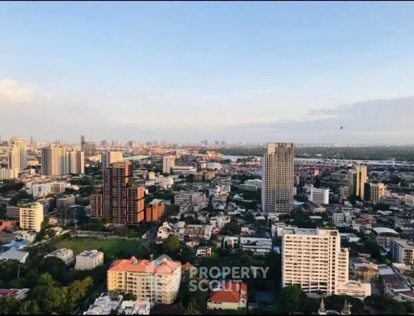 Stunning aerial view of a vibrant cityscape with modern high-rise buildings and lush greenery.