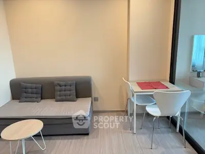 Modern living room with cozy sofa and dining area in a stylish apartment.