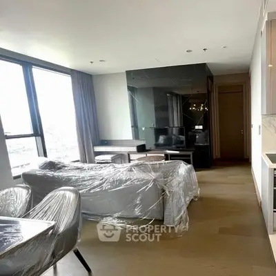 Modern living room with sleek furniture and large windows in a stylish apartment.
