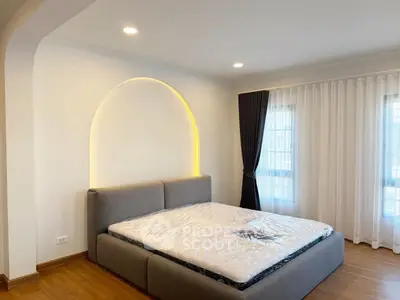 Spacious bedroom with modern design and large windows for natural light