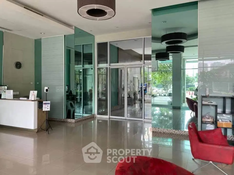 Modern building entrance with sleek glass doors and stylish interior design.