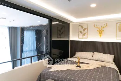 Modern bedroom with stylish decor and large window for natural light