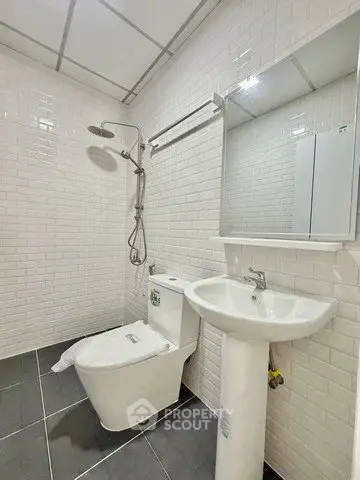 Modern bathroom with sleek white tiles and contemporary fixtures