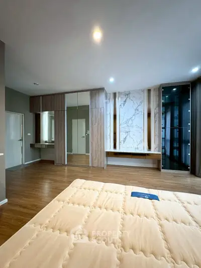 Spacious bedroom with modern design and wooden flooring