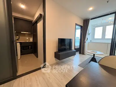 Modern apartment interior with open living area and kitchen, featuring sleek design and natural light.
