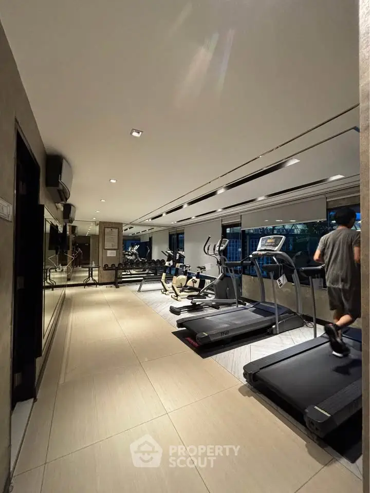Modern gym with state-of-the-art equipment in a luxury residential building.