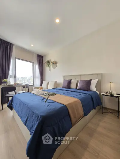 Spacious bedroom with city view, modern decor, and cozy ambiance in a high-rise apartment.