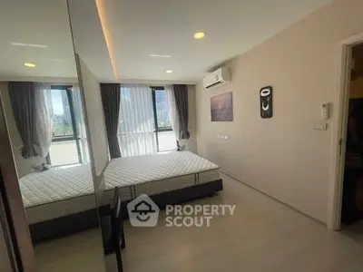 Modern bedroom with large window and air conditioning in a stylish apartment