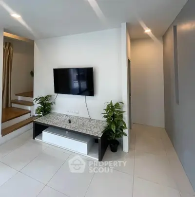 Modern living room with wall-mounted TV and sleek decor