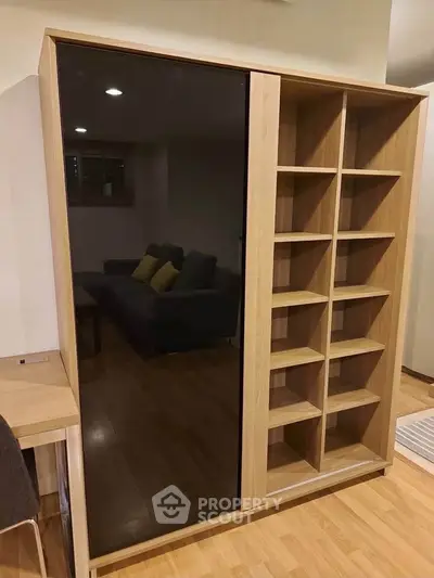 Modern living room with stylish wooden shelving unit and cozy seating area.