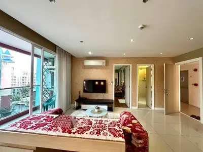 Spacious living room with modern decor and balcony view in urban apartment.