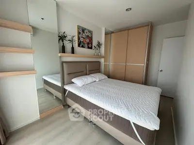 Modern bedroom with stylish decor and ample storage in a contemporary apartment.
