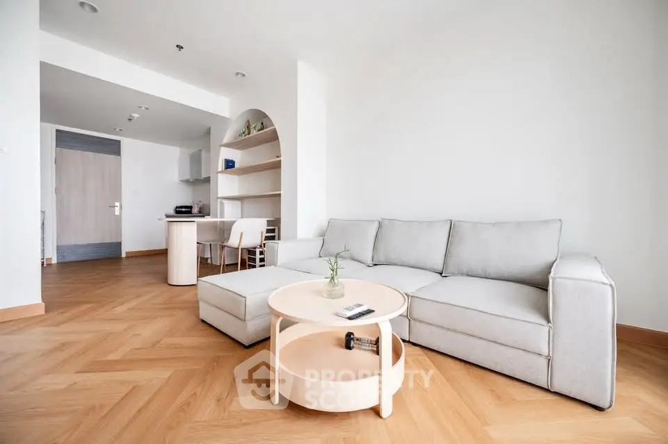 Spacious modern living room with elegant wooden flooring and cozy sofa