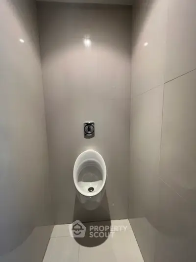 Modern bathroom with sleek urinal and minimalist design