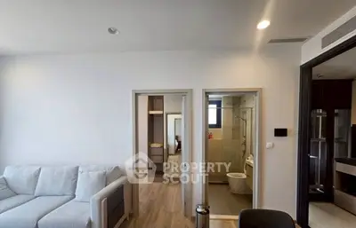 Modern apartment interior with cozy living room and adjacent bathroom