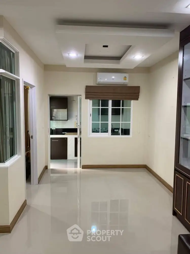 Modern interior with open layout, sleek kitchen, and glossy floors, perfect for contemporary living.